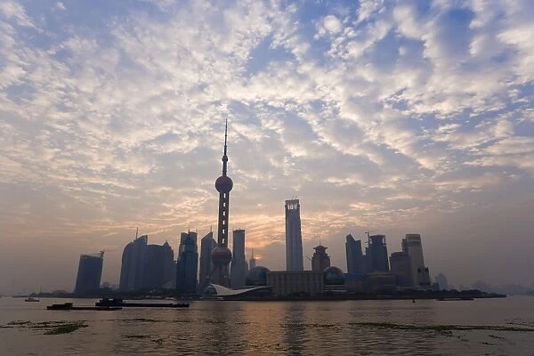 View of Oriental Pearl TV Tower and highrises in the Pudong New Area viewed across the Huangpu River from the Bund, Shanghai