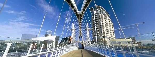 View along pedestrian suspension bridge at Salford Quays, Salford, Manchester
