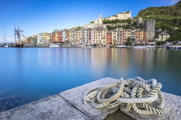 View from the pier of blue sea which frames the typical colored houses of Portovenere