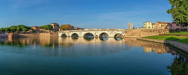 View of Ponte di Tiberio reflecting in Rimini Canal, Rimini, Emilia-Romagna, Italy, Europe