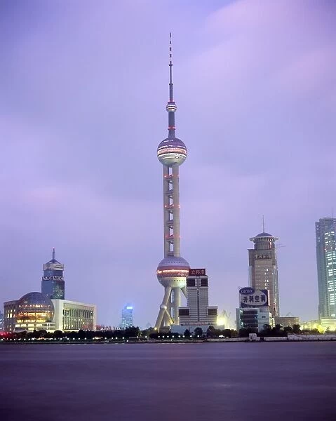 View across river at dusk to the new Pudong district skyline, Huangpu River