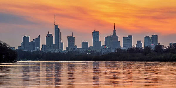 View over River Vistula towards City Centre Skyline at sunset, Warsaw, Masovian Voivodeship, Poland, Europe