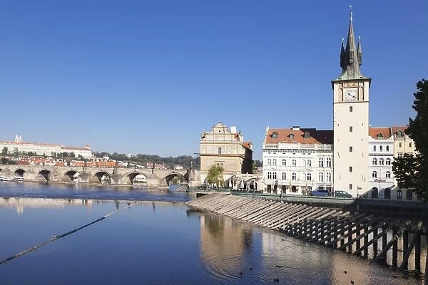 View over the River Vltava to Smetana Museum, with Charles Bridge and the Castle District in the distance, Prague, Bohemia, Czech Republic, Europe