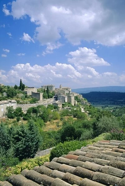 View over rooftops to village, Gordes, Luberon, Vaucluse, Provence, France, Europe