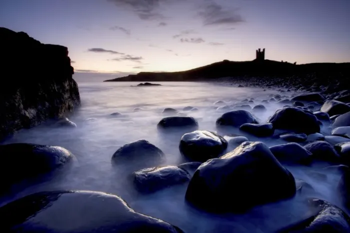 Framed Print : View across the Rumble Churn at dawn towards the ruins of Dunstanburgh Castle Framed Print : View across the Rumble Churn at dawn towards the ruins of Dunstanburgh Castle