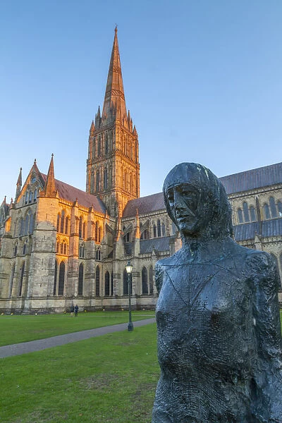 View of Salisbury Cathedral and statue at sunset, Salisbury, Wiltshire, England