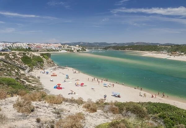 View of the sandy beach of Vila Nova de Milfontes surrounded by the turquoise ocean