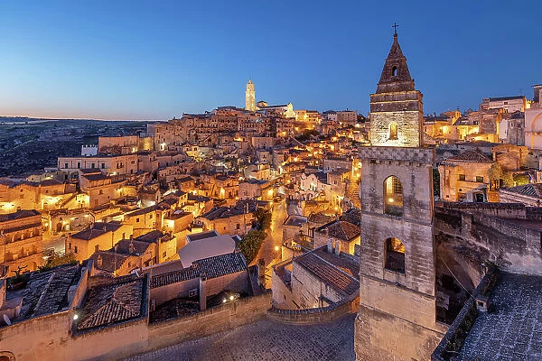 View over the Sassi di Matera old town with the campanile of the church of Saint Peter Barisano floodlit at dawn, UNESCO World Heritage Site, Matera, Basilicata, Italy, Europe