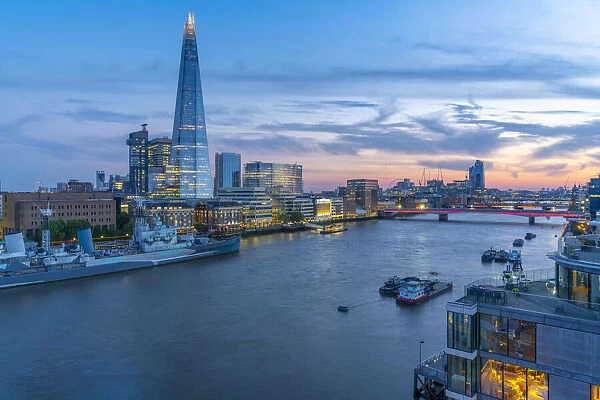 View of The Shard, HMS Belfast and River Thames from Cheval Three Quays at dusk, London