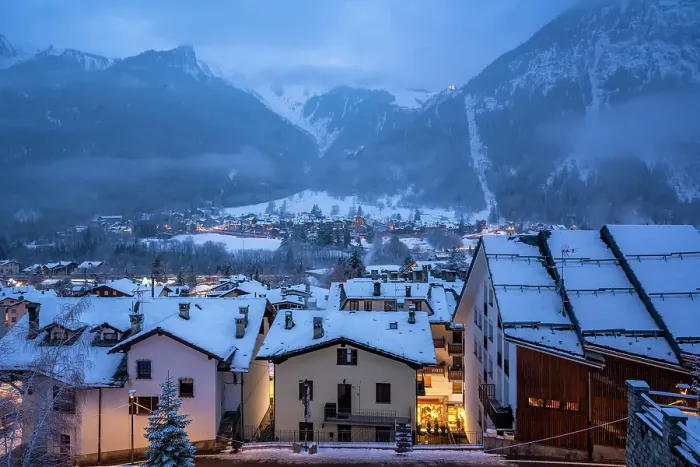 Framed Print : View of the snow covered town centre and mountainous background in winter, Courmayeur, Aosta Valley, Italian Alps, Italy