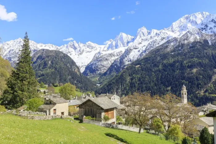 Framed Print : View of Soglio between meadows and snowy peaks in spring, Maloja, Bregaglia Valley Framed Print : View of Soglio between meadows and snowy peaks in spring, Maloja, Bregaglia Valley