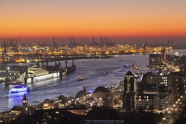 View over St. Pauli district and St. Pauli Landungsbruecken pier over the harbour at sunset