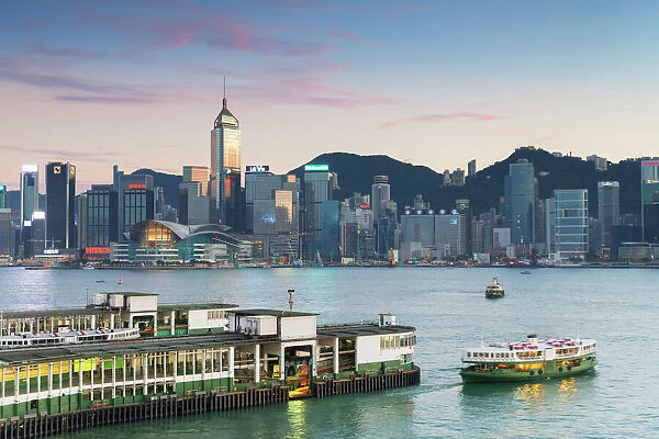 View of Star Ferry Terminal and Hong Kong Island skyline at dusk, Hong Kong, China, Asia