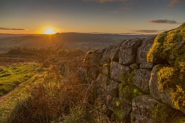 View of sunset from dry stone wall on Baslow Edge, Baslow, Peak District National Park