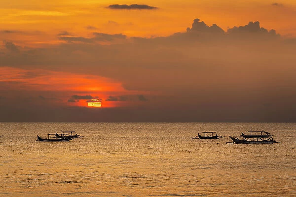 View of sunset and fishing outriggers on Indian Ocean from Kuta Beach, Kuta, Bali, Indonesia, South East Asia, Asia