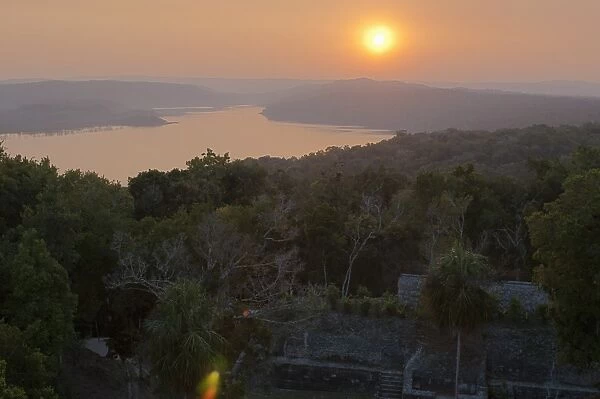 View of sunset over Lake Yaxha from Temple 216, Yaxha, Guatemala, Central America