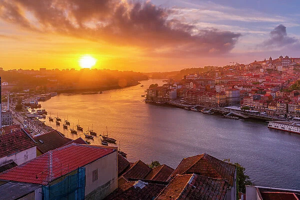View of sunset over terracota rooftops and Douro River in the old town of Porto, Porto, Norte, Portugal, Europe
