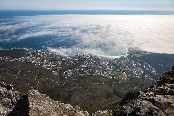 The view from Table Mountain over Camps Bay covered in low cloud, Cape Town, South Africa