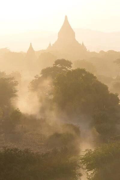 View over the temples of Bagan swathed in dust and evening sunlight, from Shwesandaw Paya, Bagan, Myanmar (Burma), Southeast Asia
