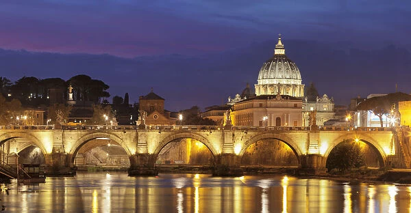 View over Tiber River to Ponte Vittorio Emanuele II Bridge and St. Peters Basilica