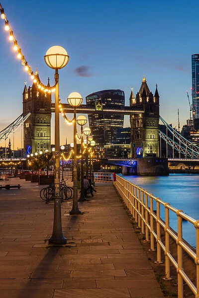 View of Tower Bridge and City of London at sunset, from Shad Thames, London, England
