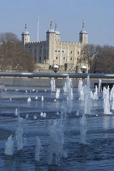 View of the Tower of London, UNESCO World Heritage Site, through fountains on the South Bank of the River Thames, near the GLC Building, London SE1, England, United