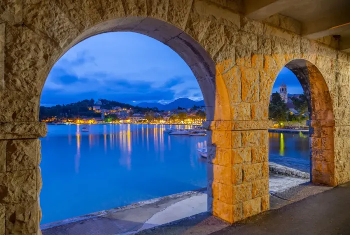 Framed Print : View of town and Crkva Sv. Nikole church through arches at dusk, Cavtat on the Adriatic Framed Print : View of town and Crkva Sv. Nikole church through arches at dusk, Cavtat on the Adriatic