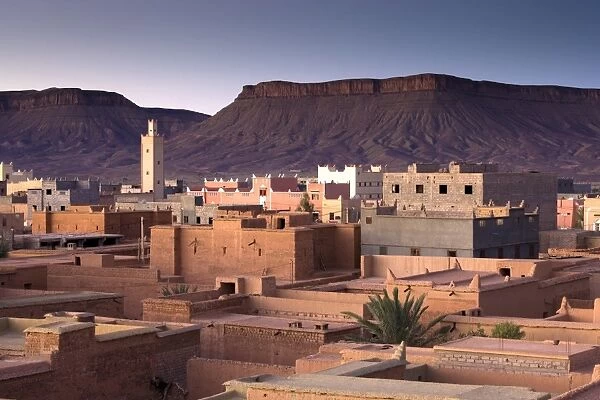 View over town of Nkob bathed in morning sunlight with modern minaret in the distance