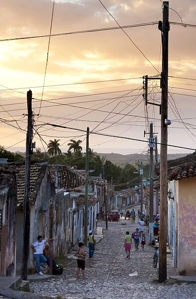 View along traditional cobbled street at sunset, Trinidad, Cuba, West Indies