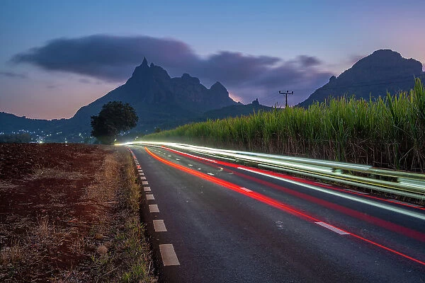 View of trail lights and Long Mountains at dusk near Beau Bois, Mauritius, Indian Ocean, Africa