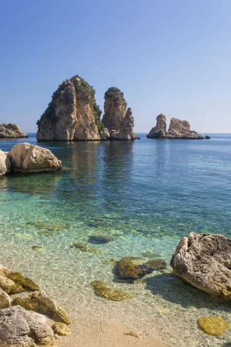 Framed Print : View across tranquil cove to the Faraglioni, a series of towering offshore rock stacks Framed Print : View across tranquil cove to the Faraglioni, a series of towering offshore rock stacks