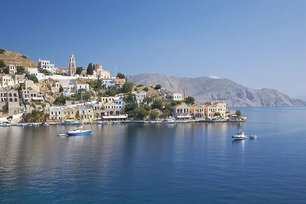 View across the tranquil waters of Harani Bay, Gialos (Yialos), Symi (Simi), Rhodes