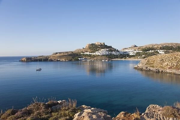 View across the tranquil waters of Lindos Bay, Lindos, Rhodes, Dodecanese Islands