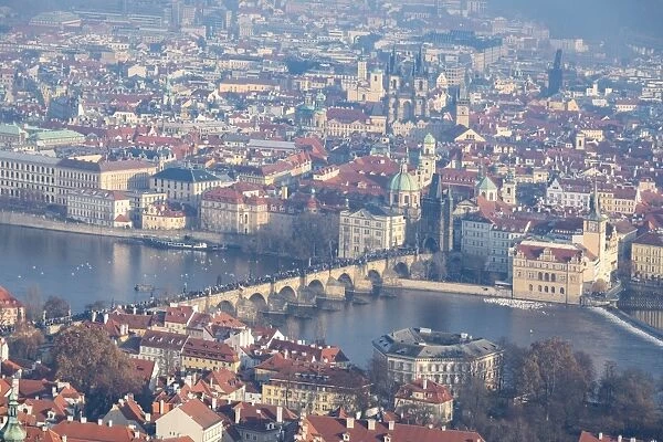 View of typical buildings and ancient churches framed by the River Vltava, Prague