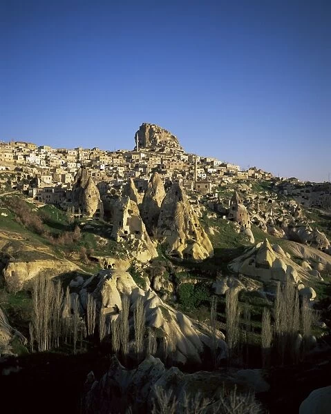 View of Uchisar with houses carved in conical rock formations