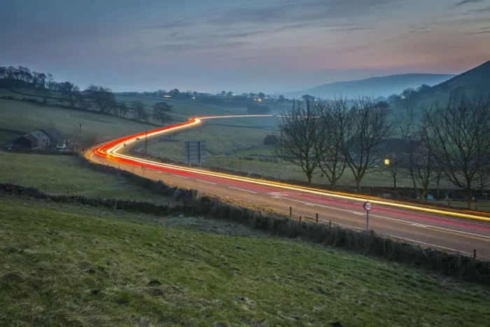 Framed Print : View of vehicle trail lights on A623 at Sparrowpit at dusk, Peak District National Park Framed Print : View of vehicle trail lights on A623 at Sparrowpit at dusk, Peak District National Park