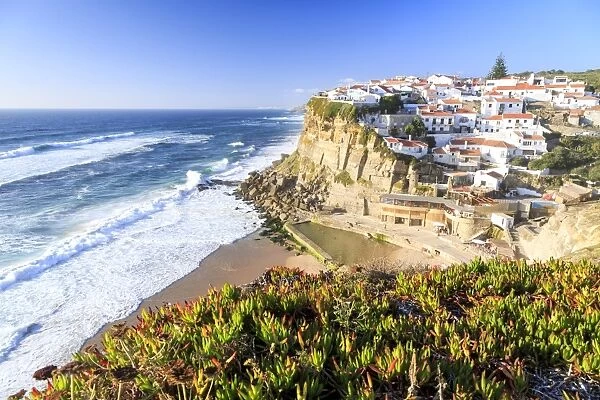 Top view of the village of Azenhas do Mar with the ocean waves crashing on the cliffs