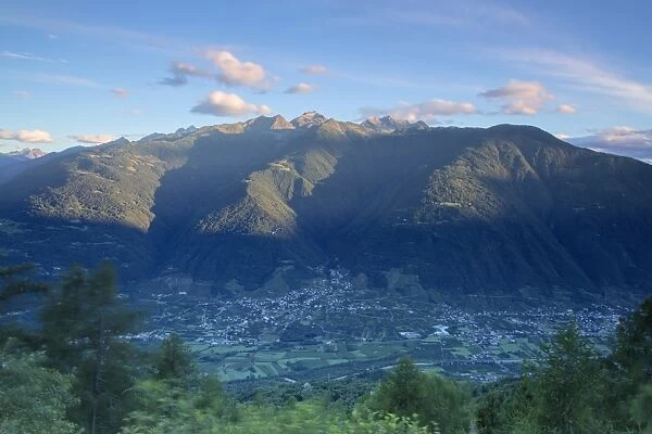 Top view of the village of Bianzone framed by the rocky peaks of the Rhaetian Alps at dawn