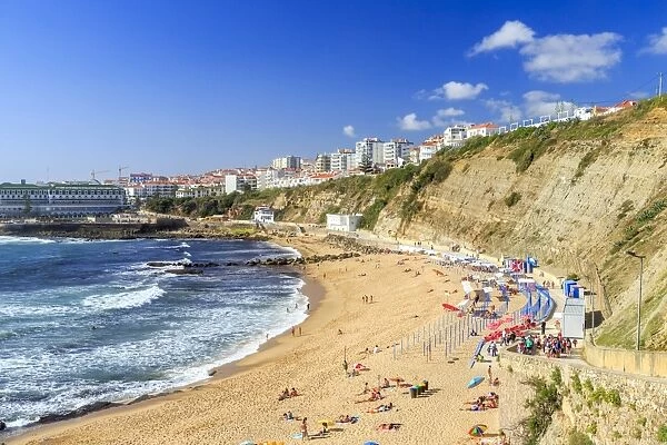 Top view of the village of Ericeira with the ocean waves crashing on the touristic sandy beach