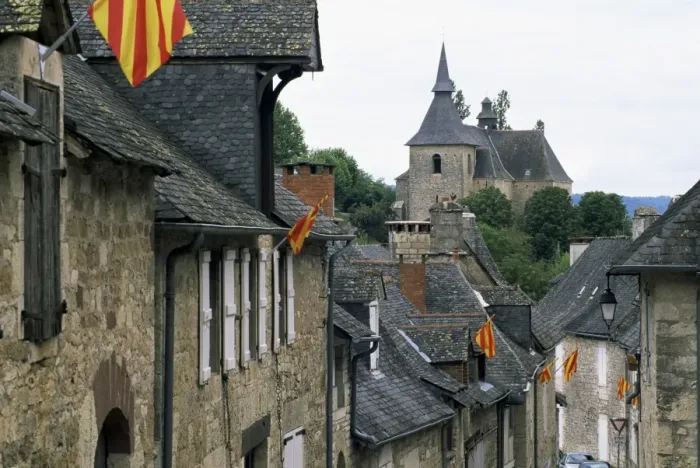 Framed Print : View along village street to church, with colourful flags, Turenne, Correze Framed Print : View along village street to church, with colourful flags, Turenne, Correze