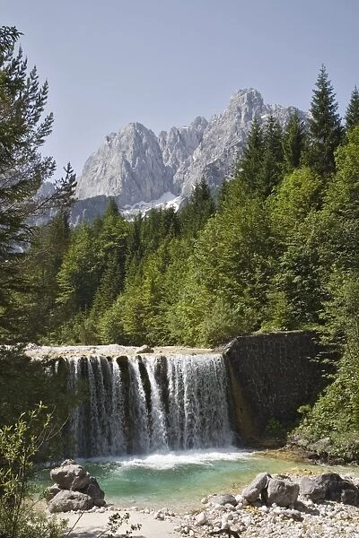 View across waterfall over weir on River Velika Pisnca