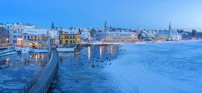 Framed Print : View of waterfront buildings and city skyline in background in the city centre of Reykjavik at dusk in winter, Reykjavik, Iceland Framed Print : View of waterfront buildings and city skyline in background in the city centre of Reykjavik at dusk in winter, Reykjavik, Iceland