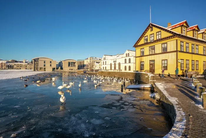 Framed Print : View of waterfront buildings and Tjornin lake on a sunny day in winter, Reykjavik, Iceland Framed Print : View of waterfront buildings and Tjornin lake on a sunny day in winter, Reykjavik, Iceland