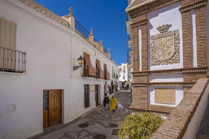 Framed Print : View of whitewashed houses and shoppers on narrow street, Frigiliana, Malaga Province, Andalucia, Spain, Mediterranean, Europe Framed Print : View of whitewashed houses and shoppers on narrow street, Frigiliana, Malaga Province, Andalucia, Spain, Mediterranean, Europe