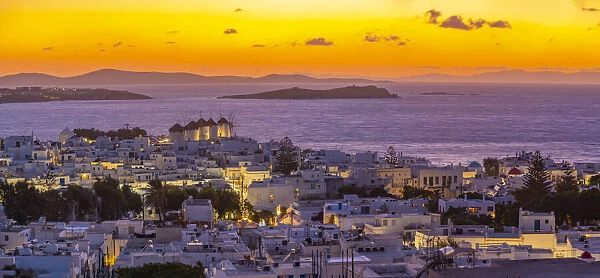 View of windmills and Aegean Sea from elevated position at sunset, Mykonos Town, Mykonos