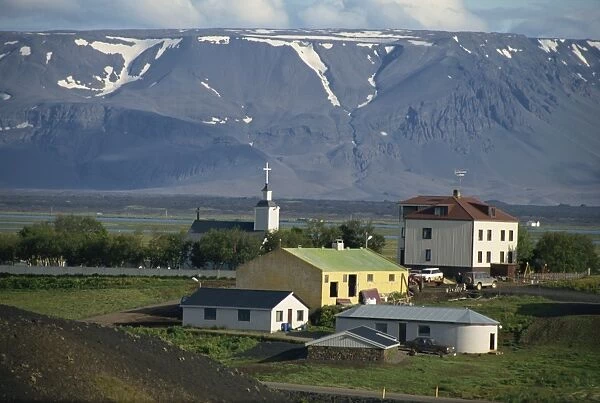 Village and church south of Lake Myvatn with hills in the background