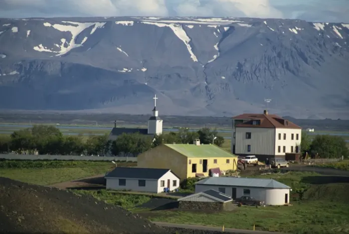 Framed Print : Village and church south of Lake Myvatn with hills in the background