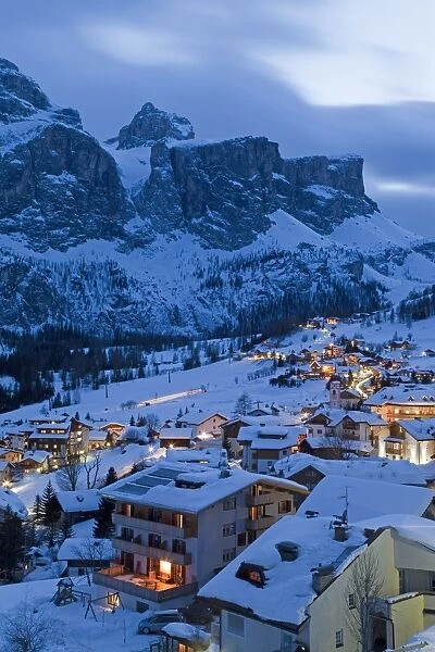 The village of Colfosco in Badia, 1645m, and Sella Massif range of mountains under winter snow