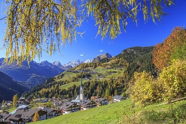 The villages of Selva di Cadore and Colle Santa Lucia, in the Dolomitic Cadore Region, surrounded by yellow larches in autumn, Veneto, Italy, Europe