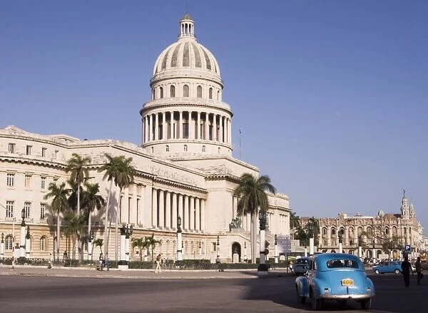 A vintage American car parked in front of the Capitolio building in central Havana